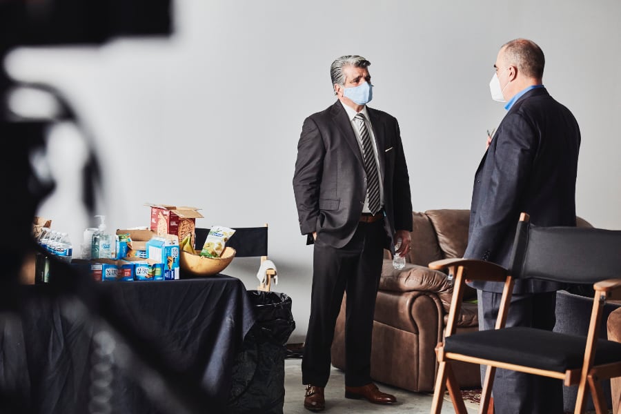 two Marmon executives wearing masks talking